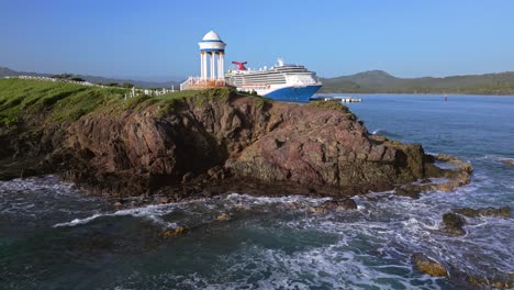 romantic gazebo on rocky promontory of senator puerto plata spa resort with cruise ship in background, dominican republic