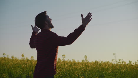 happy farmer in rapeseed field