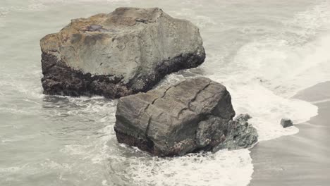 Waves-Crashing-on-California-Coast-Top-View-While-Seagull-Flies-Over