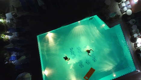 jumping in pool at night from above