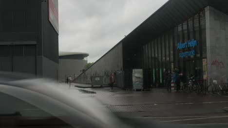 albert heijn supermarket in amsterdam on a rainy day