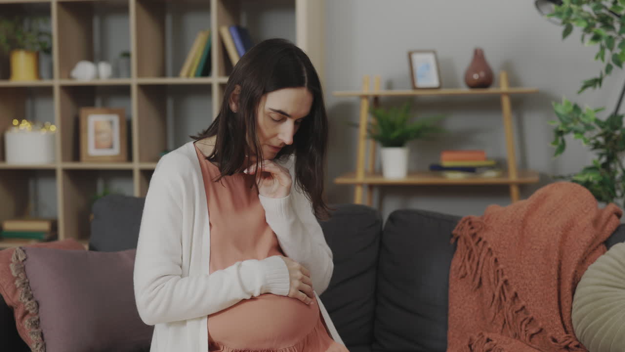 Pregnant woman feeling anxious at home