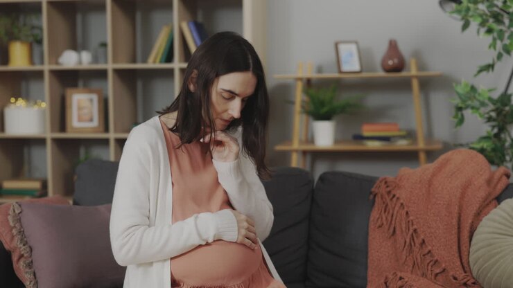 Pregnant woman feeling anxious at home