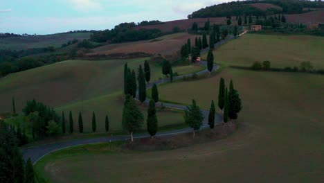 4K timelapse Drone aerial footage of a car moving on empty Road Curve in autumn  in Tuscany, Italy. Environment, traveling, car sharing concept