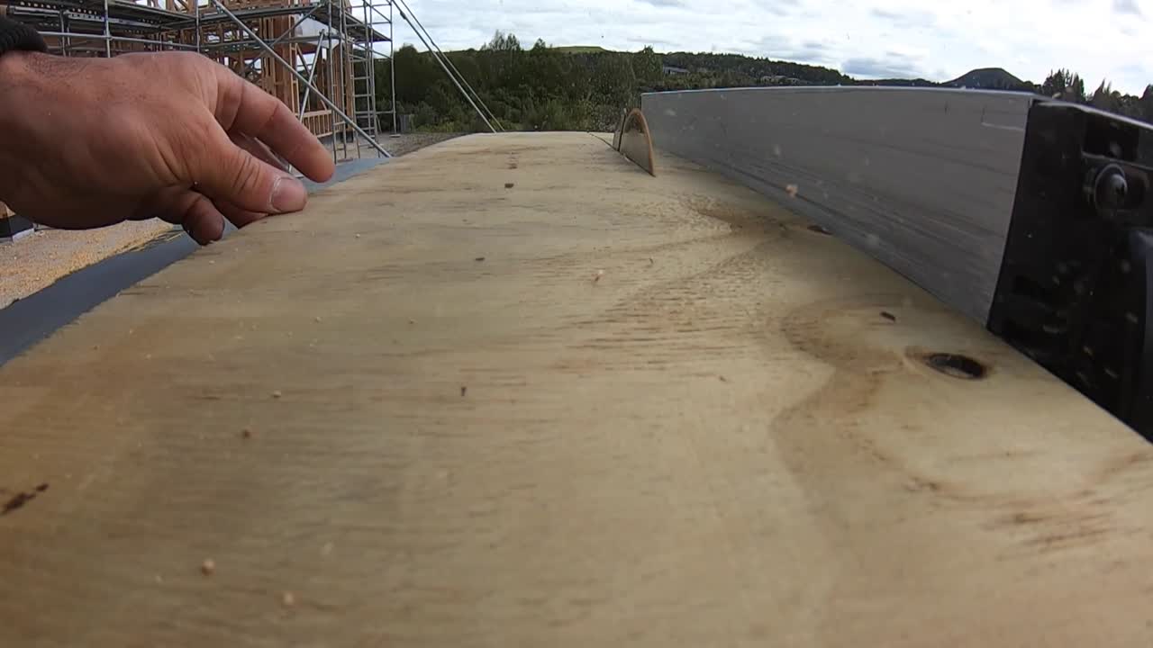 A bench saw approach close up carpenter cutting wood view in slow motion