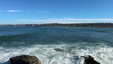 4K-Footage-of-ruff-water-ocean-swimmer-with-large-waves-at-high-tide-in-La-Jolla-Cove-in-San-Diego-California