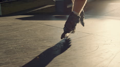 young roller skater practicing stunt at skate park. man legs in roller skates.