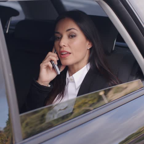 Beautiful-business-woman-on-phone-in-automobile