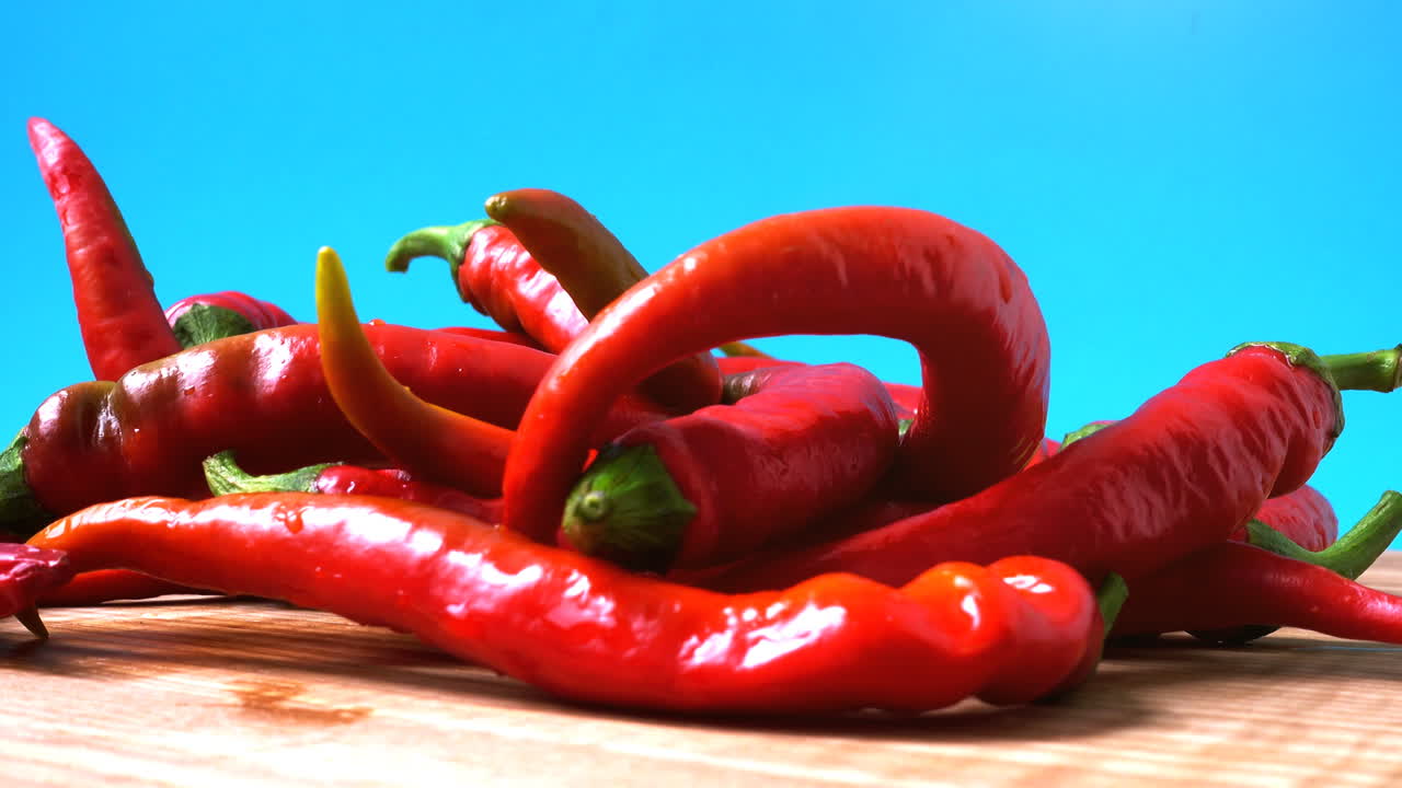 Red chilli, pepper. Shooting in the movement. Shooting in kitchen