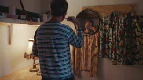 man brushing teeth in small home