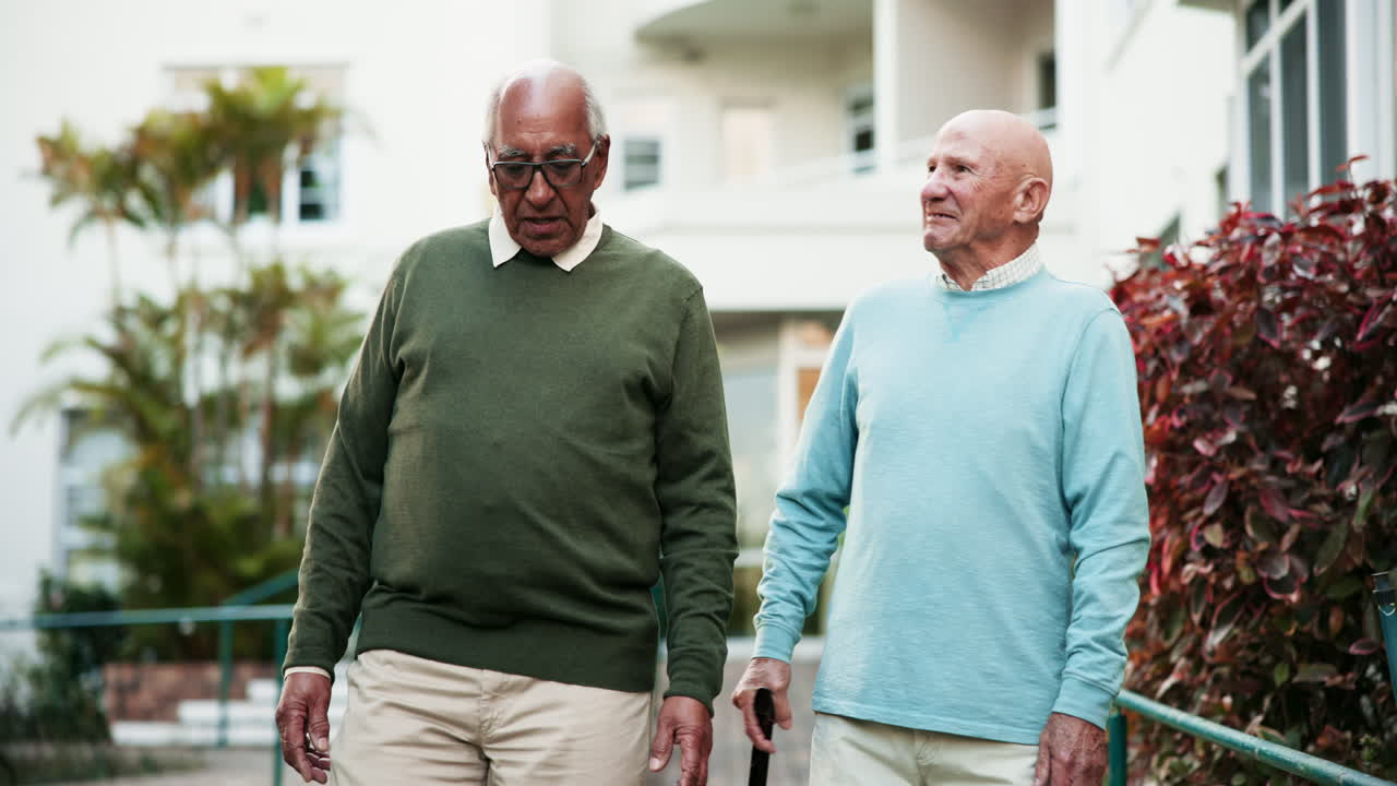 Two senior men walking together outdoors