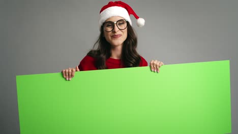 Woman-pointing-on-Christmas-banner-with-copy-space