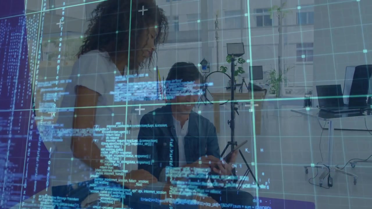 woman leaning pointing laptop screen while man tapping phone animated code overlaying tech review
