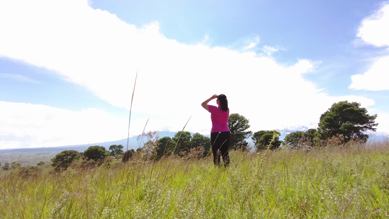 과체중인 젊은 라틴 여성은 푸에블라 멕시코 근처의 언덕을 등반한 후 자연과의 연결을 즐깁니다.