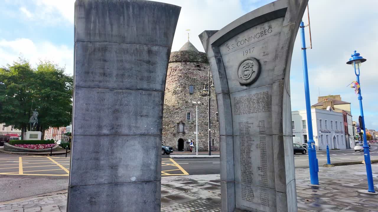 First World War memorial in Waterford Ireland with Reginald's tower from Viking times on a winter day in Irelands oldest city