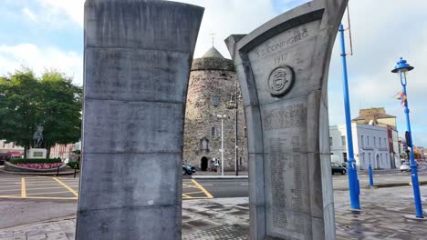 First-World-War-memorial-in-Waterford-Ireland-with-Reginald's-tower-from-Viking-times-on-a-winter-day-in-Irelands-oldest-city