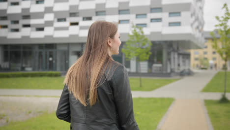 a portrait of a young girl a student near a college or modern office walking down the street with a