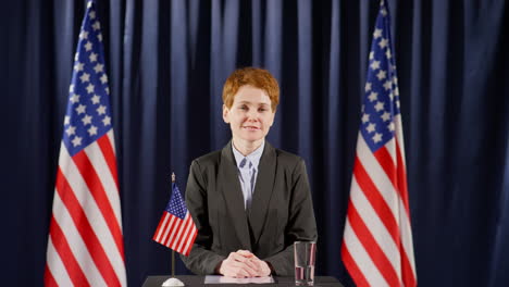 american female politician giving speech at press conference