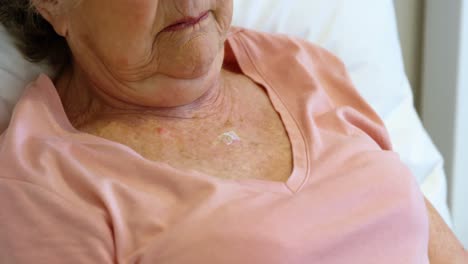 doctor putting piece of bandage on senior woman 4k