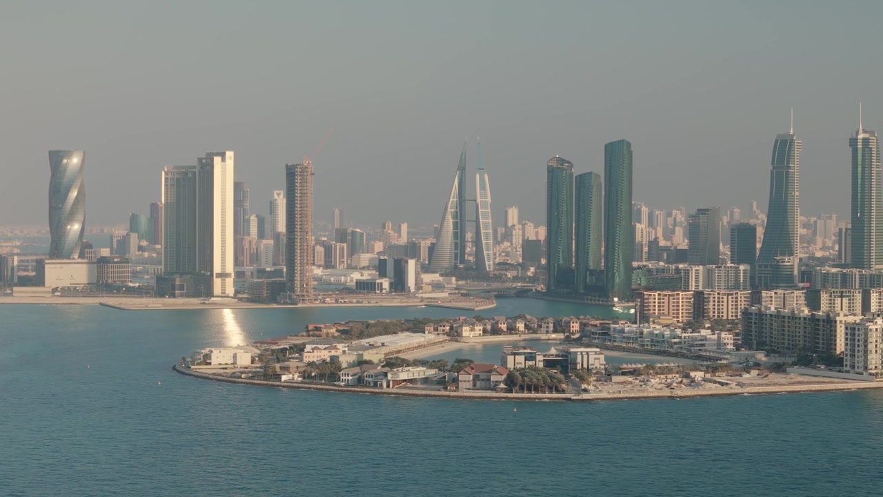 Modern architecture of manama city skyline with skyscrapers and waterfront on a hazy day