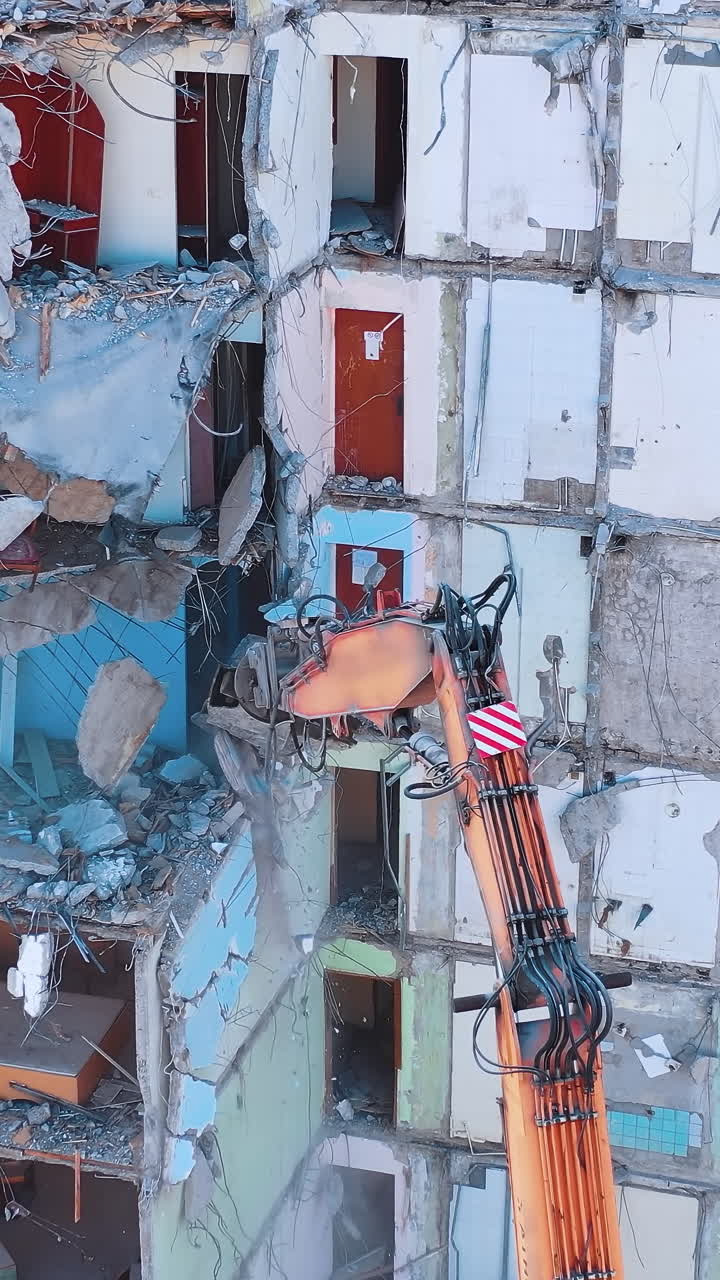 Excavator demolition constructions. Aerial view of destruction by machine.