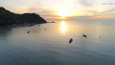 peaceful sunset over tropical sea with boats