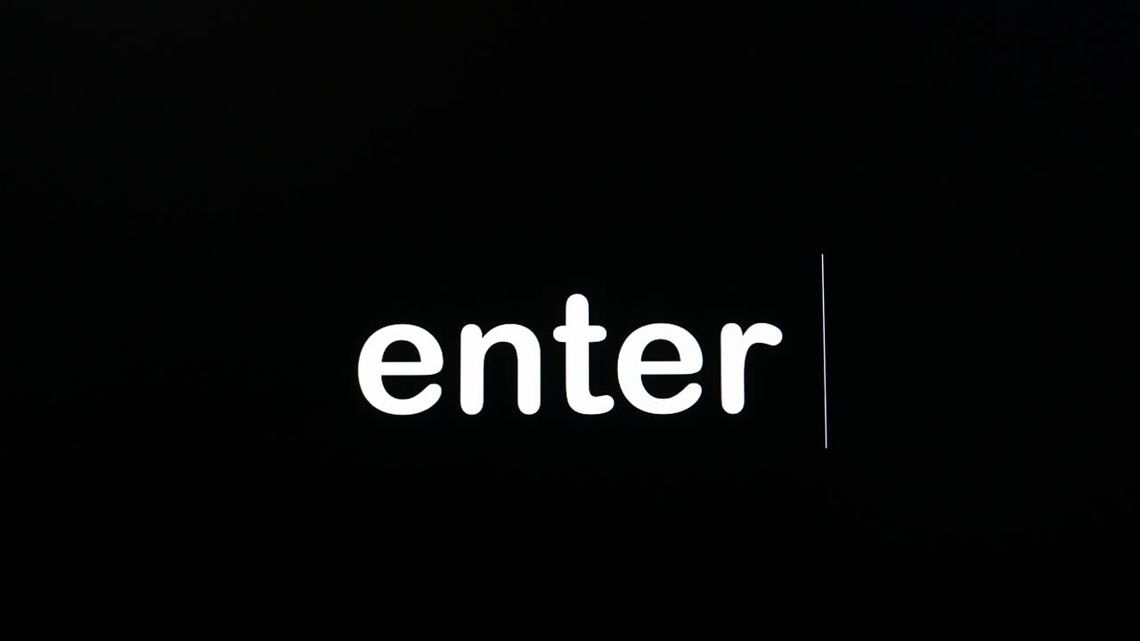Writing on the screen with a flashing paragraph forming the word enter, in white on a black background