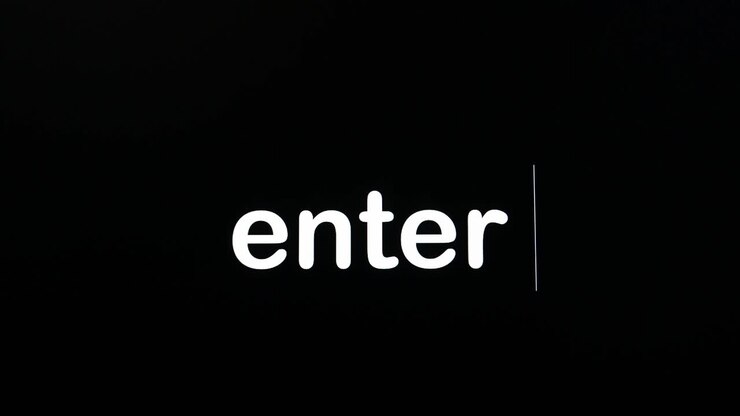 Writing on the screen with a flashing paragraph forming the word enter, in white on a black background