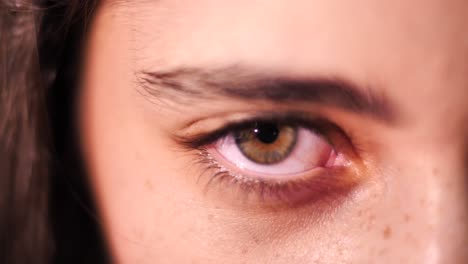 close up on brunette female opening brown eye