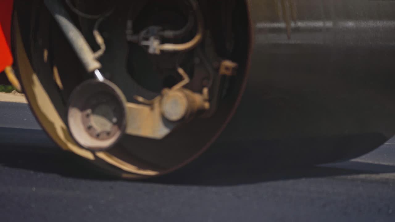 Road roller paving the asphalt road. Asphalt roller rolls fresh asphalt. Reconstruction on the highway. Close-up.