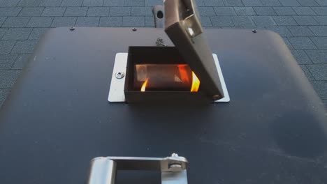 Close-up:-Flames-seen-through-top-vent-of-portable-metal-pizza-oven