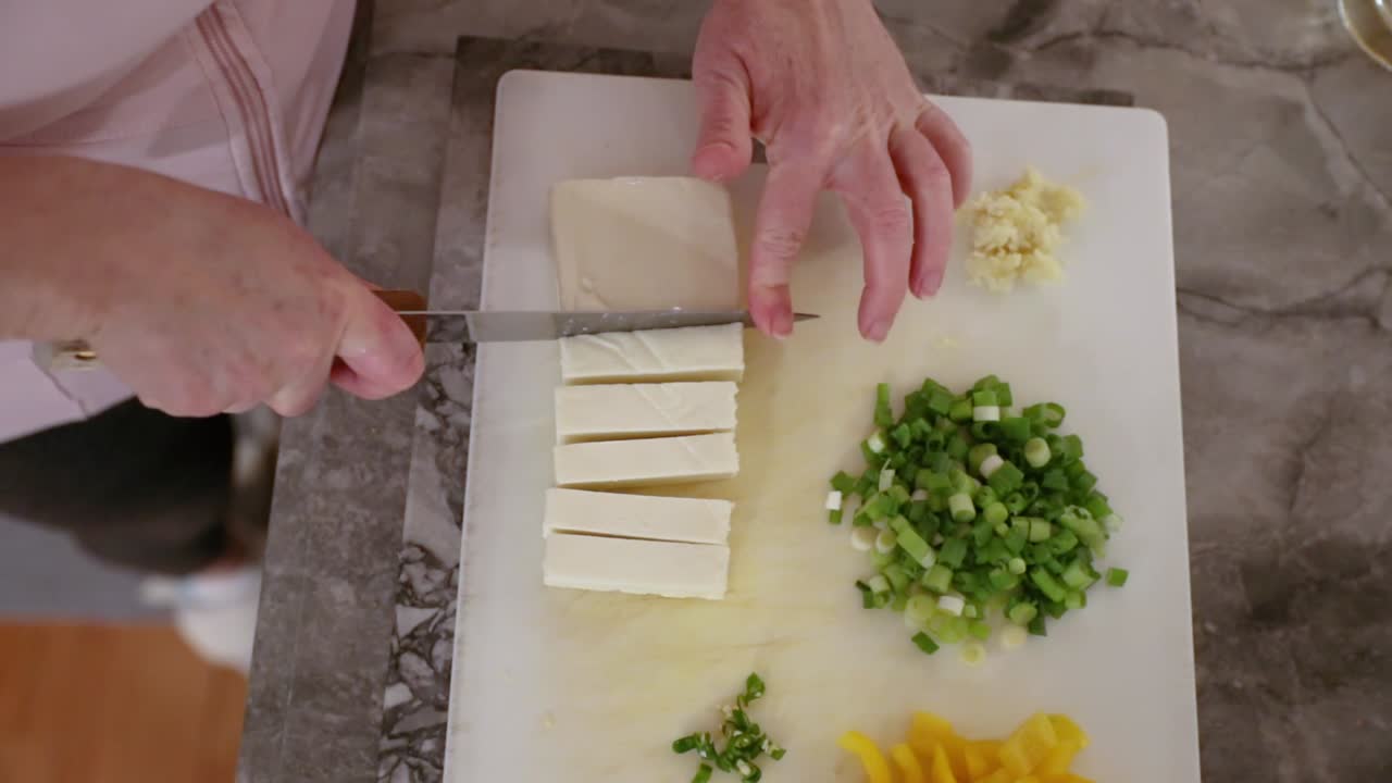 Top-Down View Of Woman Cutting Paneer In Slow Motion