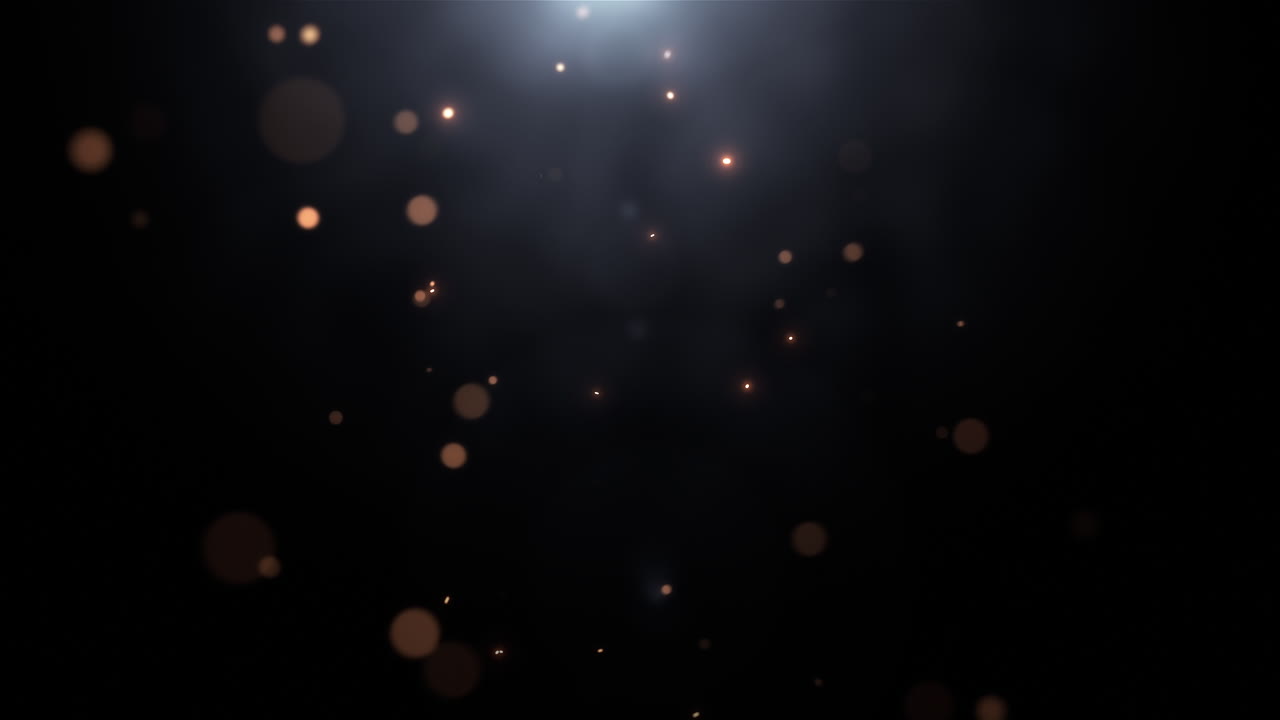 Floating Golden Particles with Light Flare on Dark Background