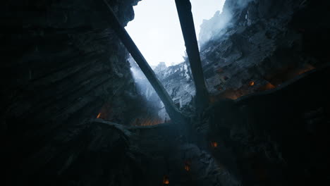 view of rocky canyon with thin bridges above and mist surrounding