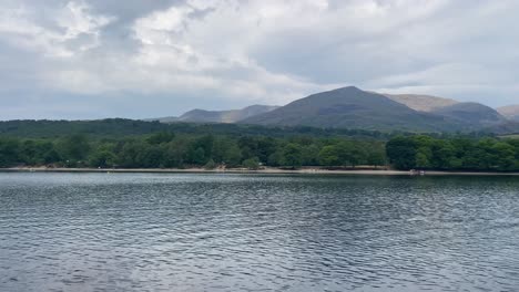 A-panoramic-view-from-a-boat-of-the-Old-Man-of-Conistion-Fell-in-the-Lake-District,-UK