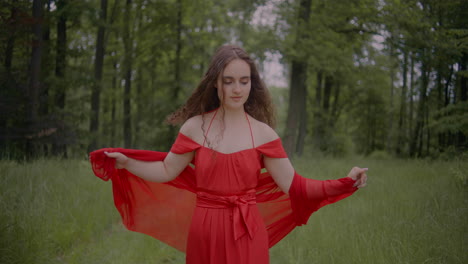 woman in red dress walking in forest