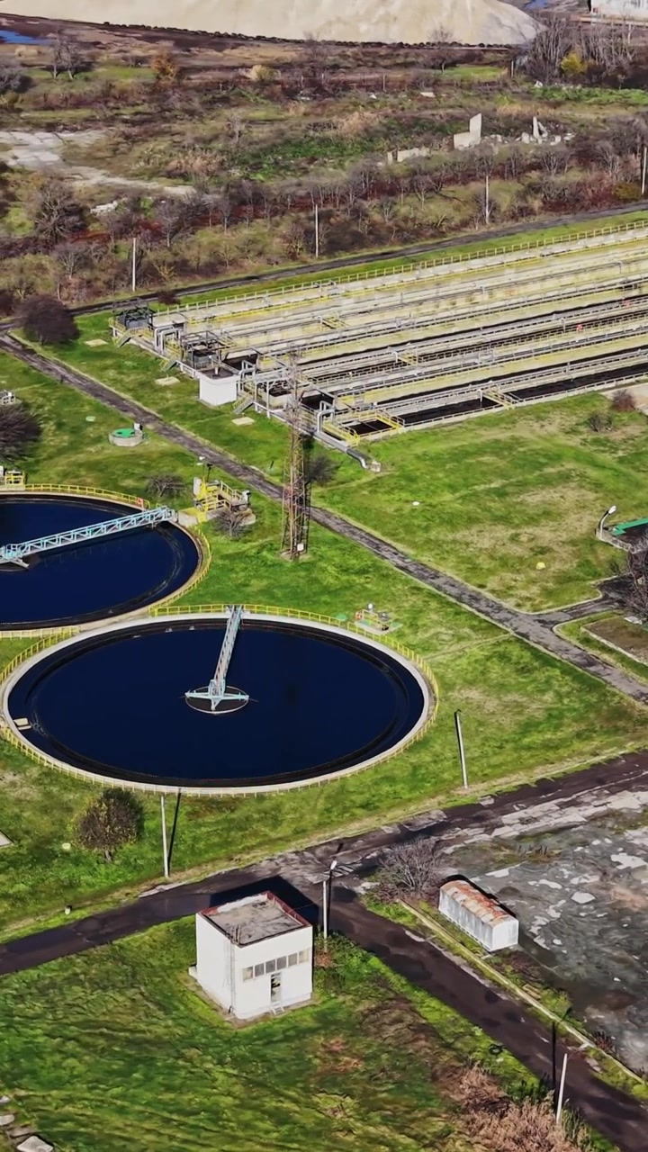 Water treatment facility located near a city with various processing tanks