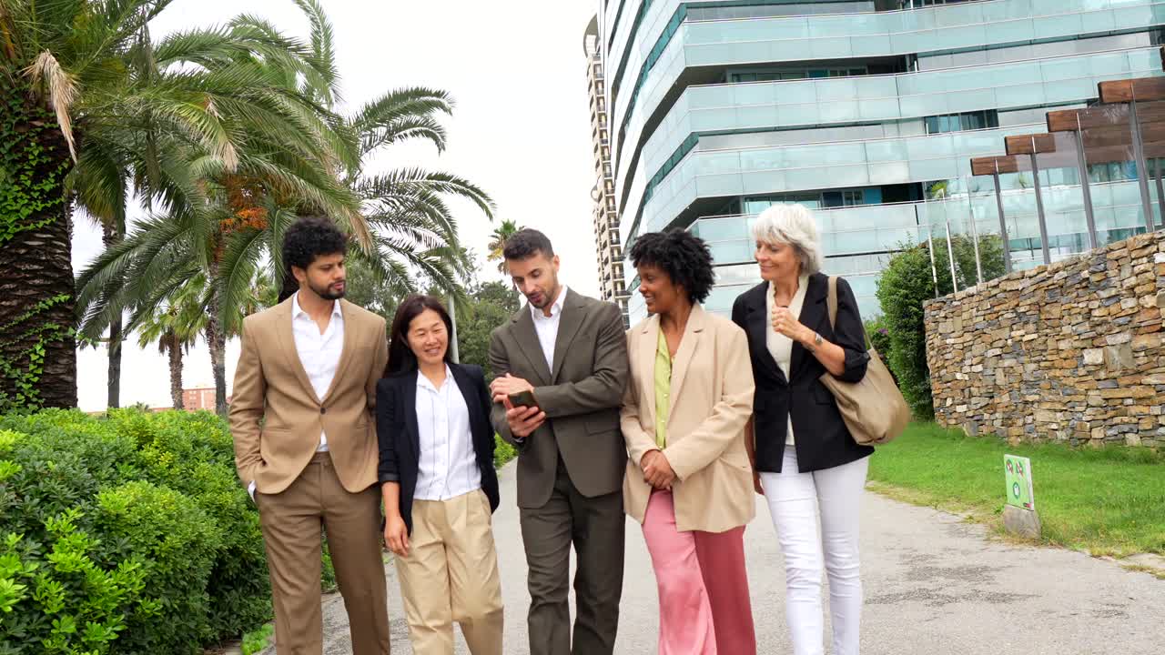 Group of diverse business people walking and talking outdoors