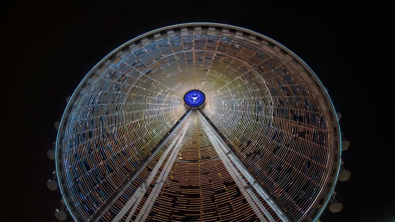 Activating lights, Ferris wheel turning at fair, with blue hub, support legs, LED rings, gondolas