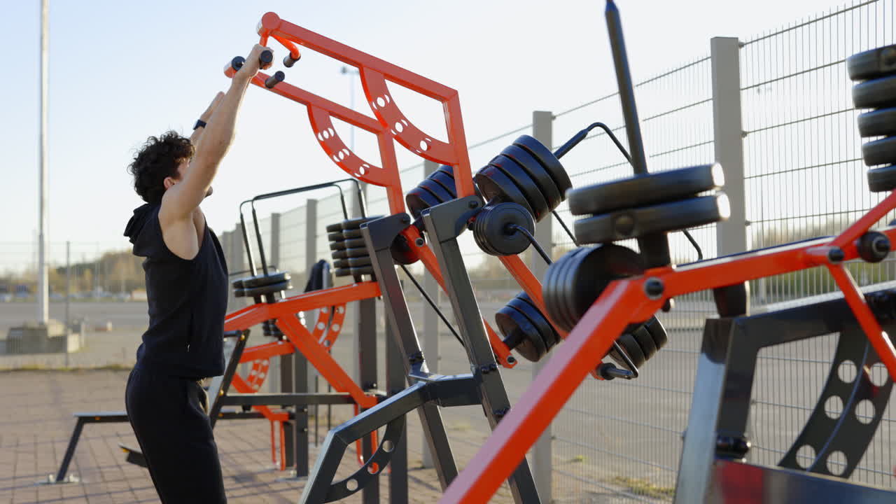 Man Working Out on Outdoor Gym Equipment