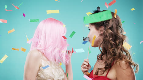 Girlfriends-dancing-wearing-red-dress-and-pink-hair-in-slow-motion-party-photo-booth