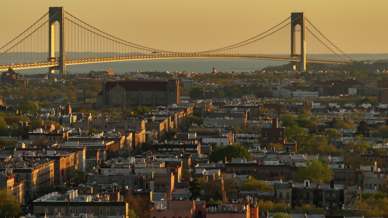 Aerial view of rush hour traffic on Brooklyn's Belt Parkway. Shot at sunset in Bay Ridge with the Verrazzano Bridge in the background.