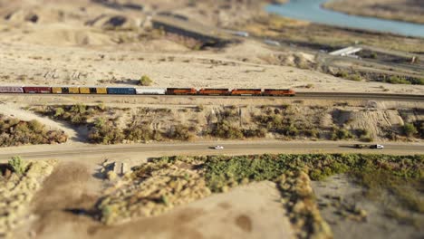 US-Train-on-rails-with-i40-in-background-tilt-shift-lens