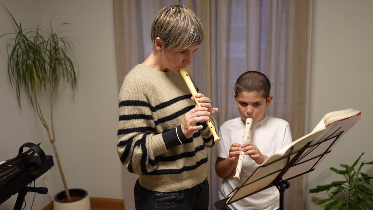 Woman and Boy Playing Recorders Together from Sheet Music