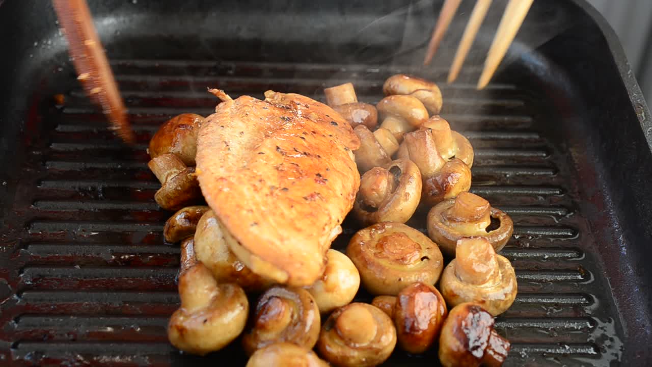 We fry mushrooms with chicken on a grill. We cook a dish