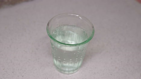 pouring water into a glass close-up shoot