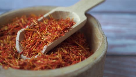 dried saffron in wooden bowl with spoon