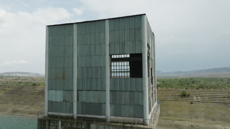 abandoned desolate sheet metal control tower in dali mta reservoir