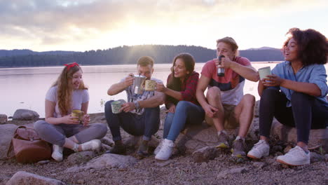 friends enjoying campfire coffee by the