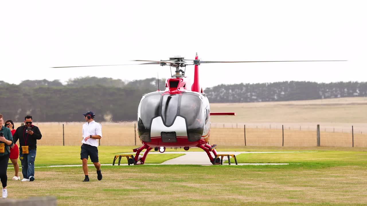 Red Helicopter Landing on a Field